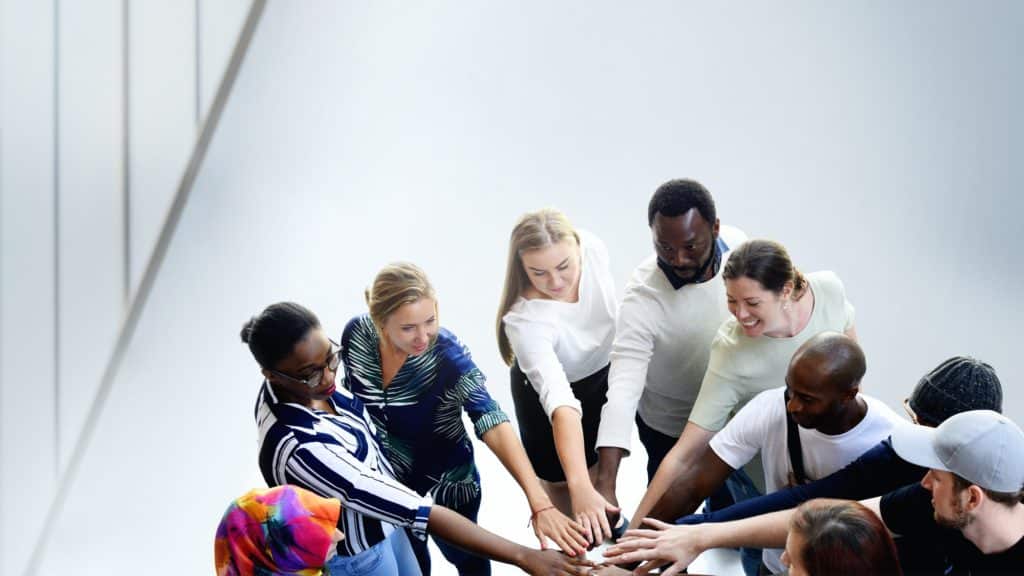 Group of diverse people stacking hands