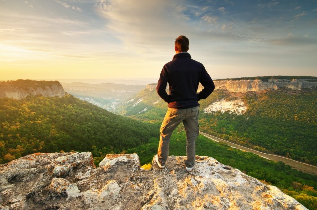 Man on top of mountain.
