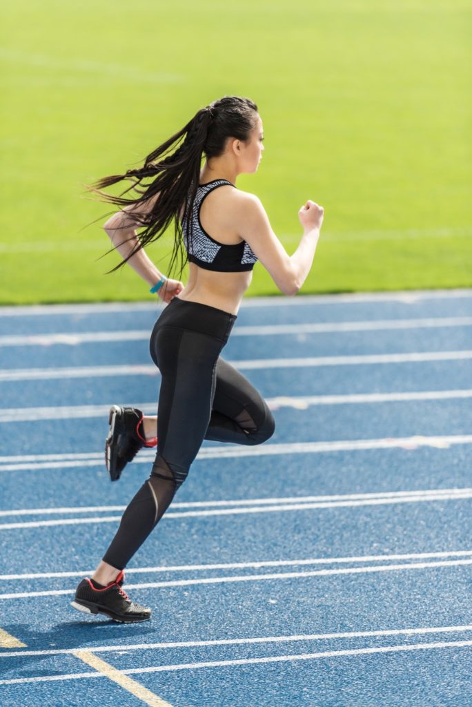 woman athlete running on tracks
