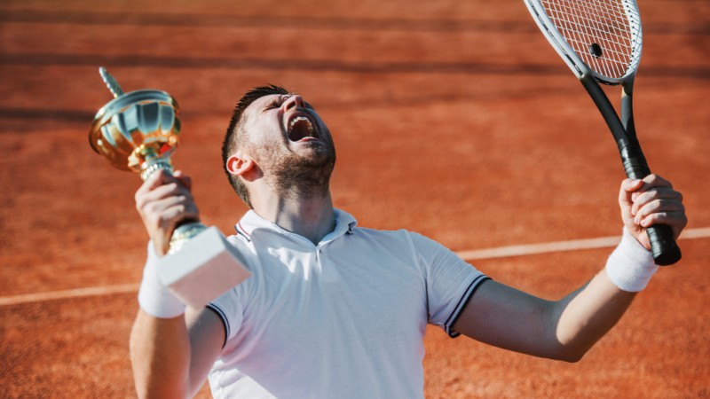 Un joueur de tennis venant de gagner un tournoi grâce à un bon coaching mental