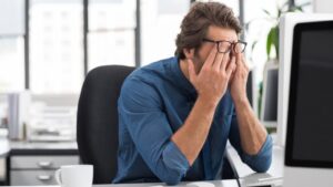 Un homme irrité au travail à cause d'un burn-out